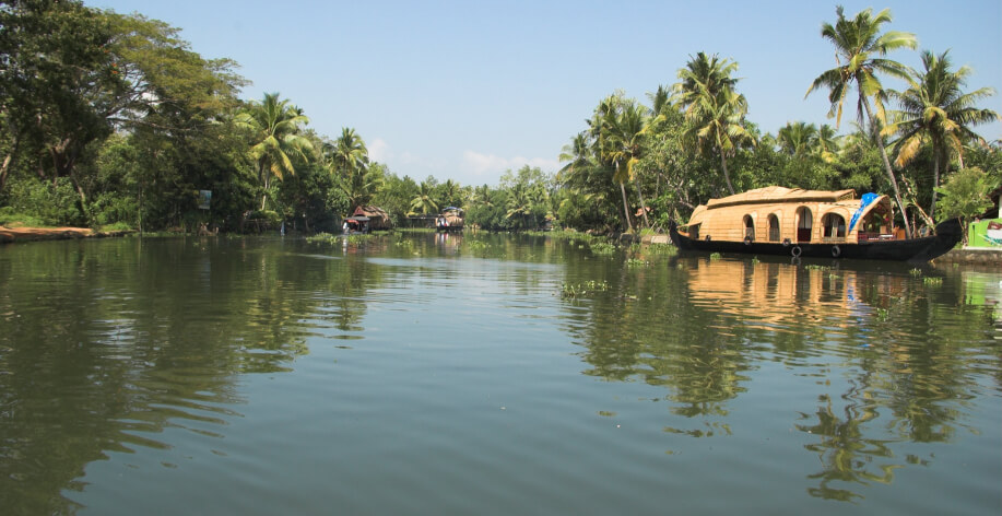 A Houseboat is crusing through Vembanadu Lake in Kumarakom