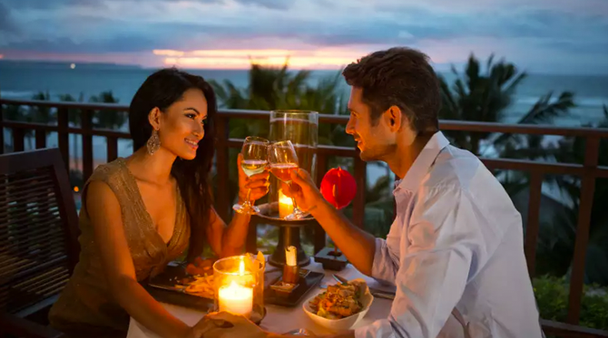 A Honeymoon Couple Enjoying Candle lit dinner during their Kerala Honeymoon Package Tour
